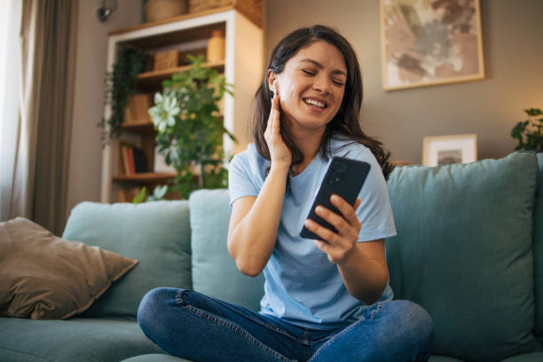 istock Woman sitting at the sofa and singing. 2040067785