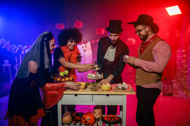 istock Friends enjoying snacks and chatting during a Halloween party 2040074854