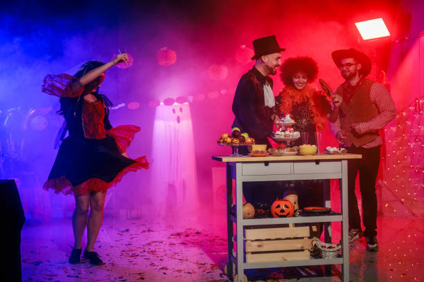 istock Dancing, enjoying snacks and having fun during a Halloween party 2040080311