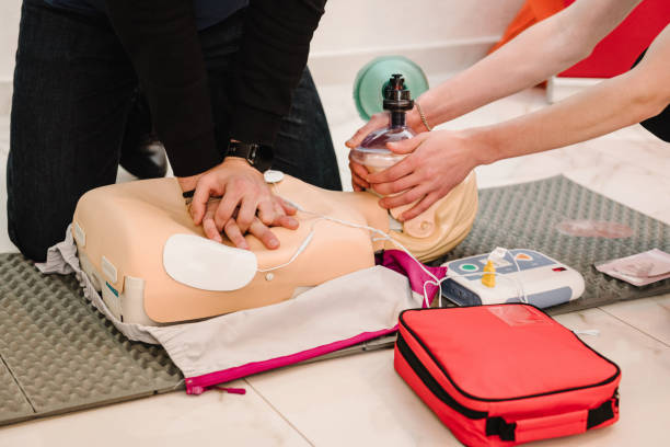 istock Indirect heart massage. Automated external defibrillator device, AED with training dummy mannequin. Use an automatic defibrillator in conducting basic cardiopulmonary resuscitation of victim. Closeup 2040090457
