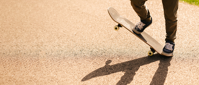 Close up photo of teenager boy on skateboard.