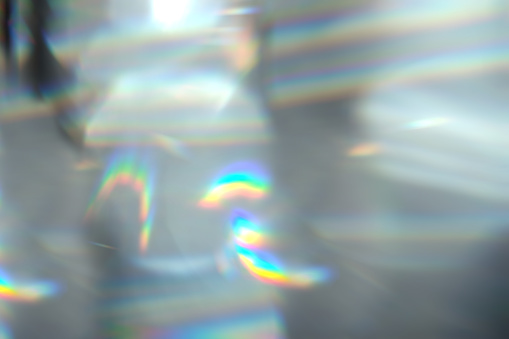 Glare effect on a black background. An abstract lens flare for on-screen use. Glare of the optical rays of the lens.