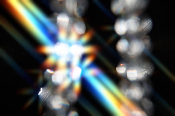 Optical effect from glass faceted beads on a black background.