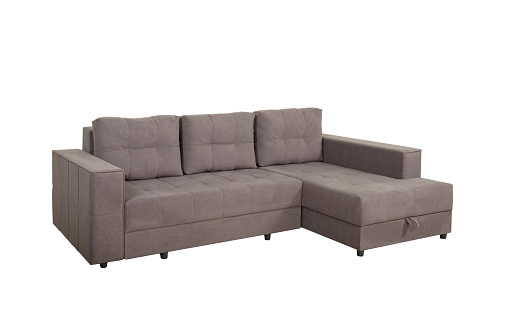Gray corner sofa with velor fabric pillows isolated on a white background. Cushioned furniture.