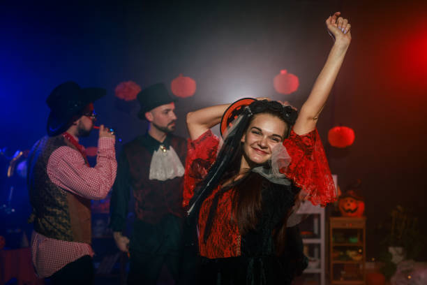 istock Charming young woman dancing in costume during a fun Halloween party 2040135523
