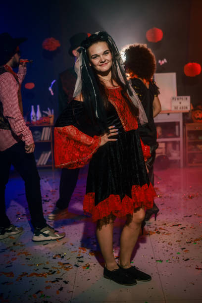 istock Charming young woman dancing in costume during a fun Halloween party 2040135537