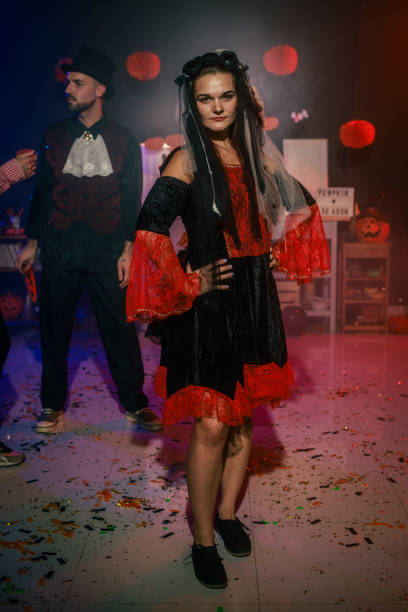 istock Charming young woman dancing in costume during a fun Halloween party 2040135539