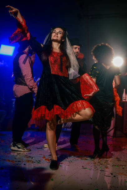 istock Charming young woman dancing in costume during a fun Halloween party 2040135541