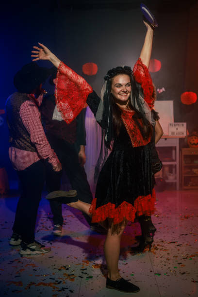 istock Charming young woman dancing in costume during a fun Halloween party 2040135545