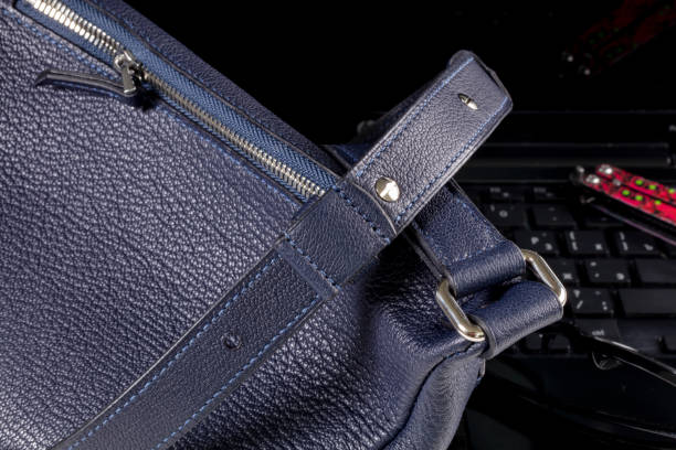 istock Part of a blue leather bag on a black background. Leather goods. 2040140412