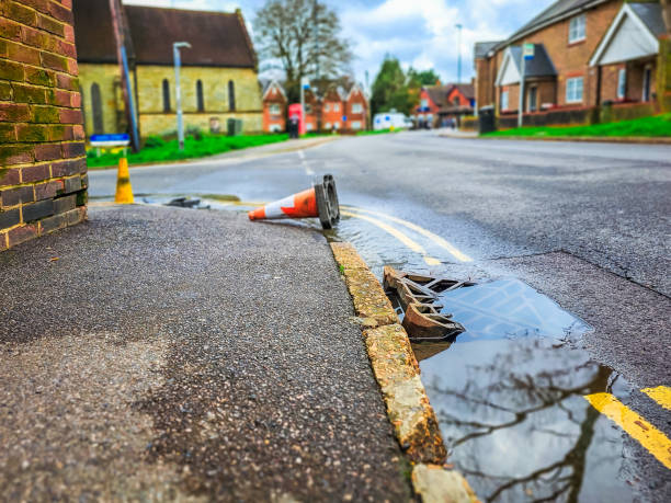 Drain overflowing with water at the roadside
