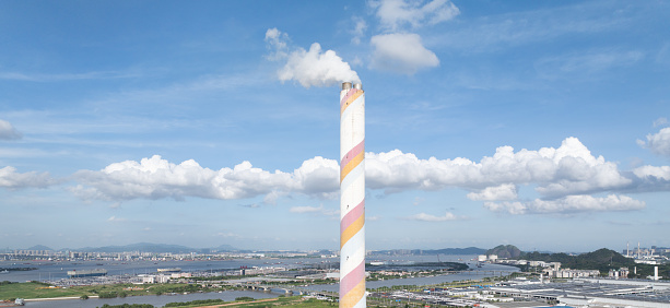 Smoking chimneys and blue sky with white clouds