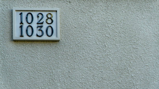 istock Numbers 1028 and 1030 made of marble on a concrete wall 2040181462