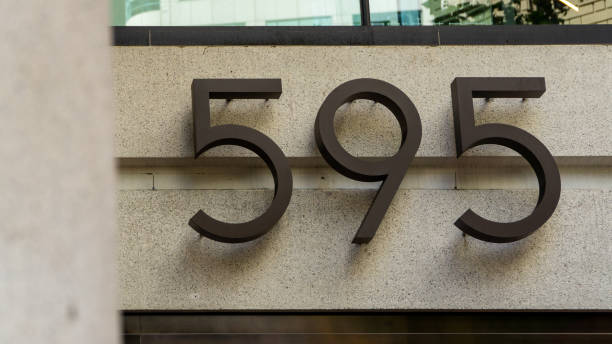 istock Number 595 made from metal on a concrete wall 2040183087