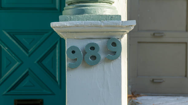 Number 989 made of stone on a concrete wall