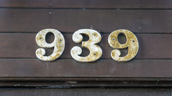 San Francisco, USA - August 2019: Close up of number 939 made of wood on a wooden wall