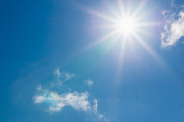 istock Shining sun at clear blue sky,clouds.Solar lens flare. copy space.Natural lens flare.Sunrays of bright sun on summer day. 2040195974