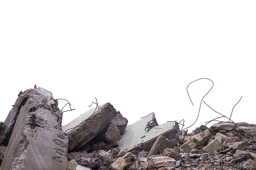 Grey concrete fragments of a destroyed building isolated on a white background. The cut object.