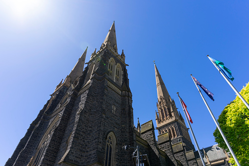 St Patrick's Cathedral and spire with blue sky in Melbourne, Australia.