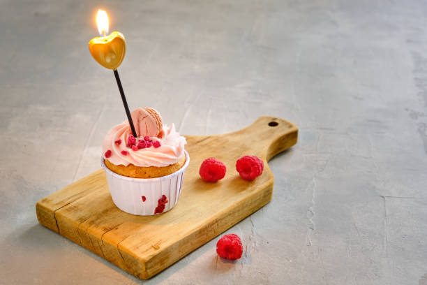 Tasty raspberry cupcakes on white background