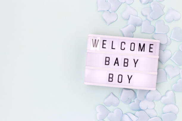 welcome baby boy. lightbox with letters and blue confetti in a heart shape. - human pregnancy baby shower image color image 뉴스 사진 이미지