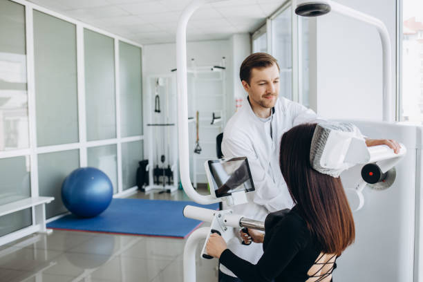 istock Young woman making spine examination in diagnostics machine with physiotherapist. 2040219767