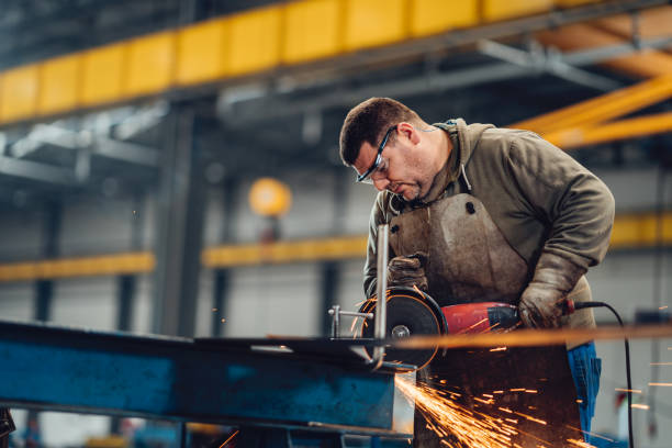 istock Factory worker cutting metal with grinder. 2040230922