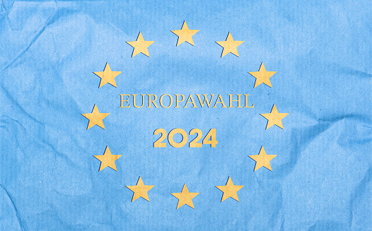 Text Europawahl - European Elections 2024. Text in silhouette - paper cut out style. European union flag Paper Background.