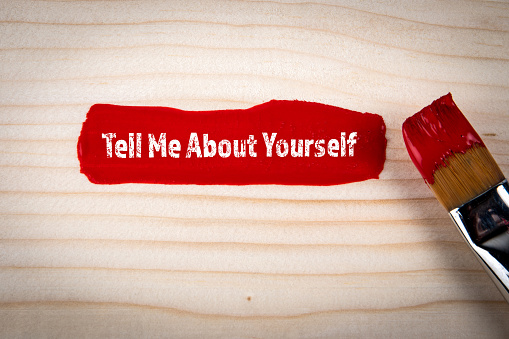 Tell Me About Yourself Concept. Red color on wood texture background.