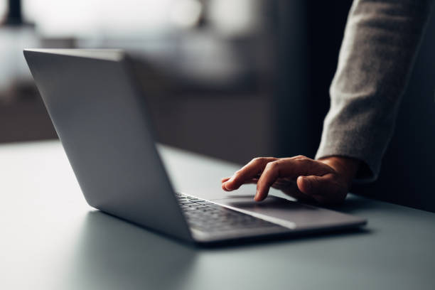 Close-up of a Professional Working on Laptop in Modern Office