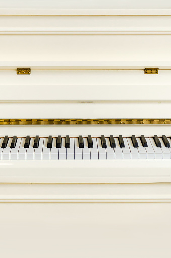 White piano. Piano keys close up, space for text. Piano keyboard.