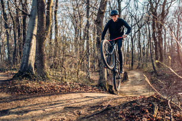istock Extreme mountain biker jumping and performing aerial maneuvers on a forest track 2040242507