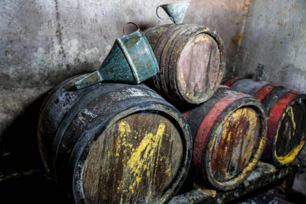 Old vintage wine barrels, an old metal watering can