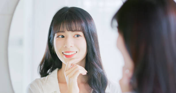 istock asian beauty satisfies her teeth 2040285252