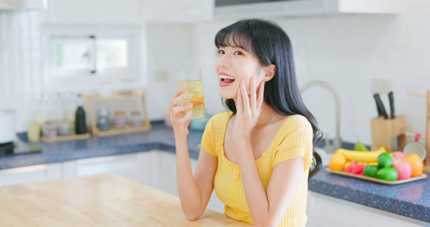 istock asian woman happily drink icewater 2040286912