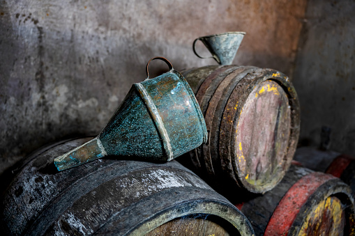 Old vintage wine barrels, an old metal watering can