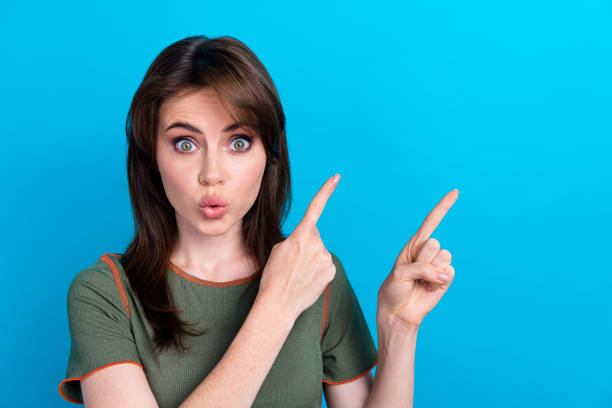 istock Photo of impressed nice lady pouted lips indicate fingers empty space ad blank isolated on blue color background 2040321095