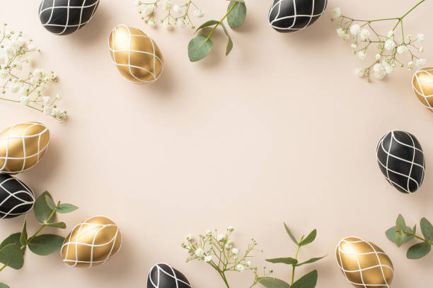 istock Spring elegance theme: Overhead shot featuring luxurious black and gold eggs fresh eucalyptus sprigs, baby's breath blooms, set on a soft cream canvas with space for copy 2040341518