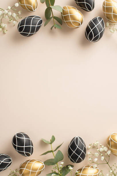 istock Easter luxury design: Vertical top view of lavish black and gold eggs, organic eucalyptus branches, delicate gypsophila, arranged on a pale beige canvas, with ample space for text or advertisement 2040341528