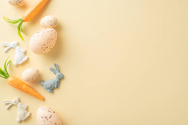 istock Cozy Easter theme. Top view photo featuring Easter hare decor, a variety of eggs, and decorative carrots on a light beige backdrop, leaving ample space for text or advertisements 2040342078