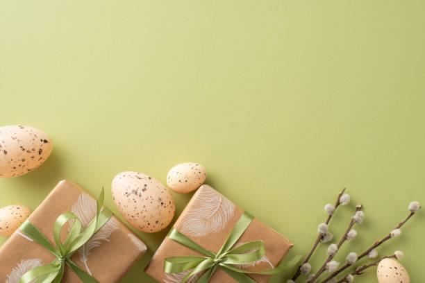 istock Charming Easter display inspiration. Top view of handmade gift wraps, quail eggs, wild pussy willow branches, organized on a light green backdrop with space for text or advertising 2040342090