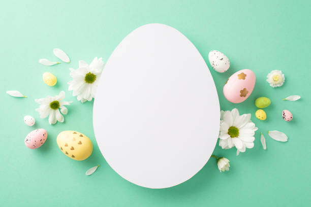 istock Spring celebration design: top view picture of multi-hued eggs, and budding chamomiles on an aqua base, with an empty egg-shaped placeholder for text or publicity 2040342630