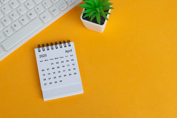 April 2025 desk calendar on yellow background. Directly above. Flat lay. April 2025 desk calendar on yellow background. Directly above. Flat lay. Copy space. april stock pictures, royalty-free photos & images