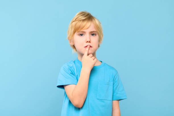 istock Young pensive boy, trying to find solution to a problem, studio portrait isolated on pastel blue background. 2040346874