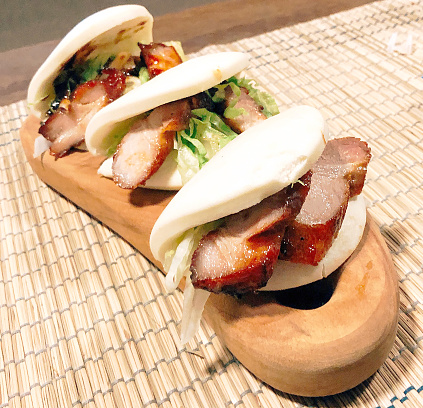 Pork Belly Buns is made by soft fluffy Bao buns stuffed with tender sticky pork belly and lettuce