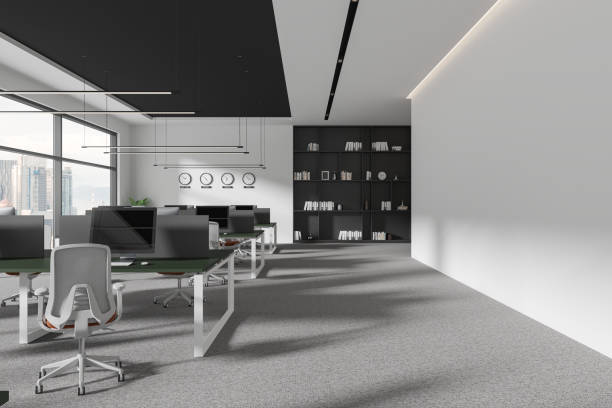 istock Cozy coworking interior with pc desktop, world clock and panoramic window 2040376982