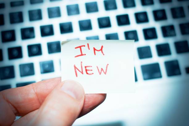 I am new written on a memo on the keyboard at the office