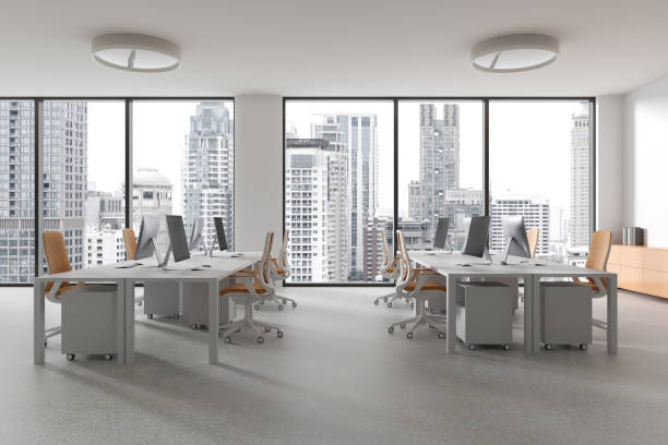 istock Coworking interior with pc computers and armchairs in row, panoramic window 2040393107