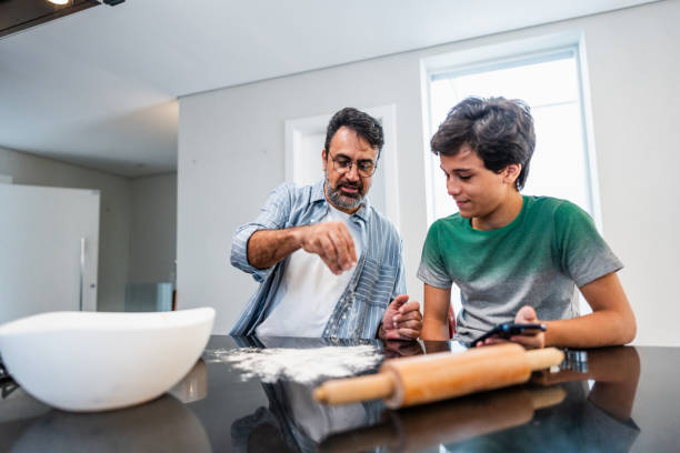 istock Father and son cooking together at home 2040402652