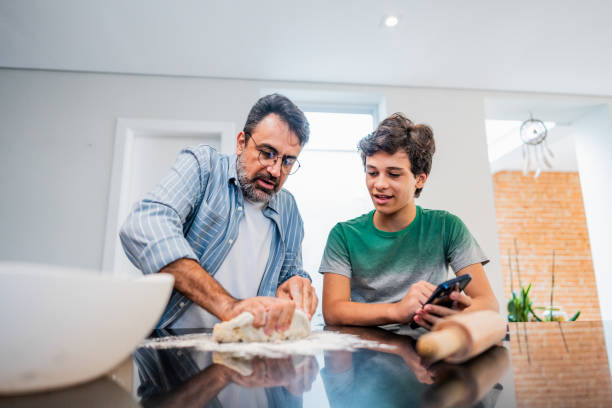 istock Father and son cooking together at home 2040402670